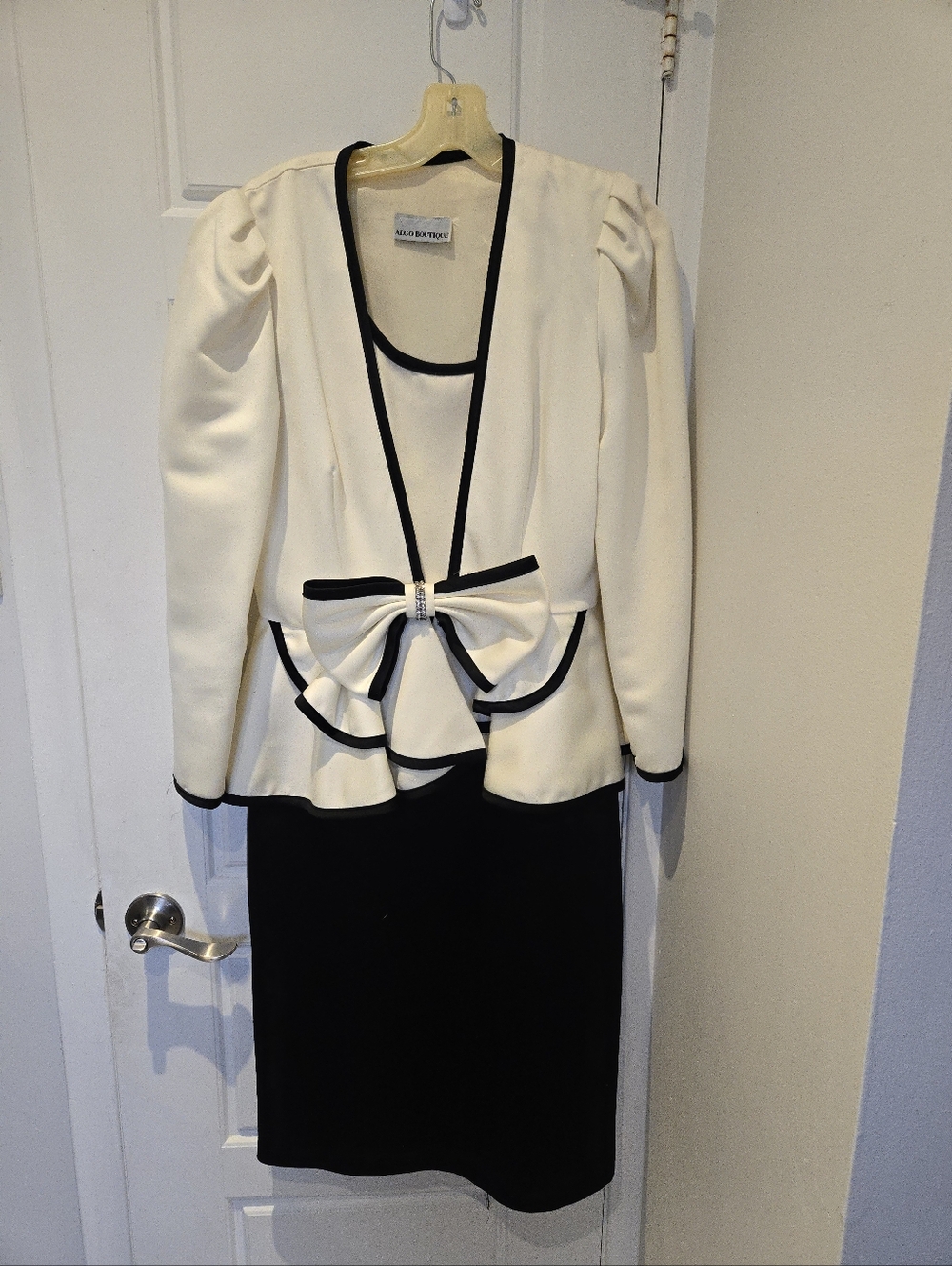 White and Black Peplum Dress with Bow Accent